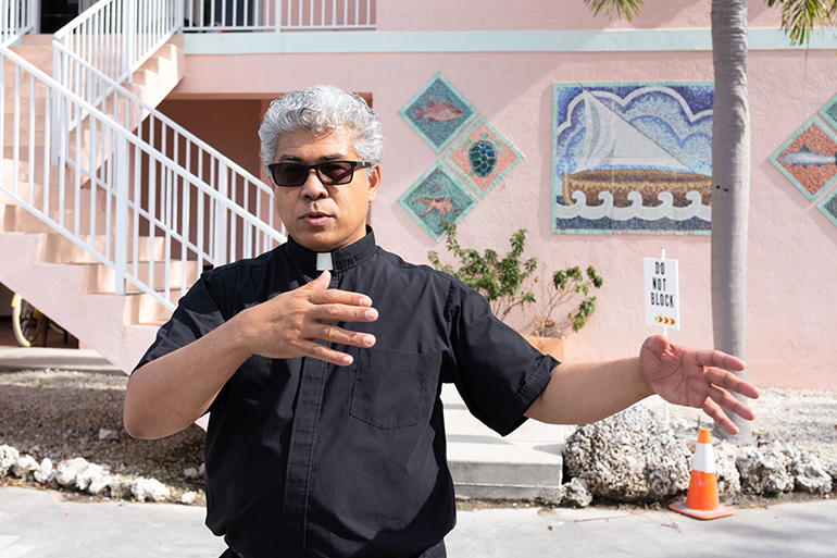 At St. Peter Parish in Big Pine Key, Father Jets Medina, parochial administrator, speaks to members of the Catholic Charities Board of Directors during their tour of Monroe County churches and projects.