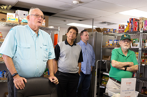 Marty Mara, left, chairman of the building committee at St. Peter Church in Big Pine Key, talks about the community food bank project at the parish. Listening are Peter Routsis-Arroyo, CEO of Catholic Charities in the Archdiocese of Miami, center, and members of the Charities Board of Directors who were on a tour of the churches and Catholic Charities projects in the Keys.