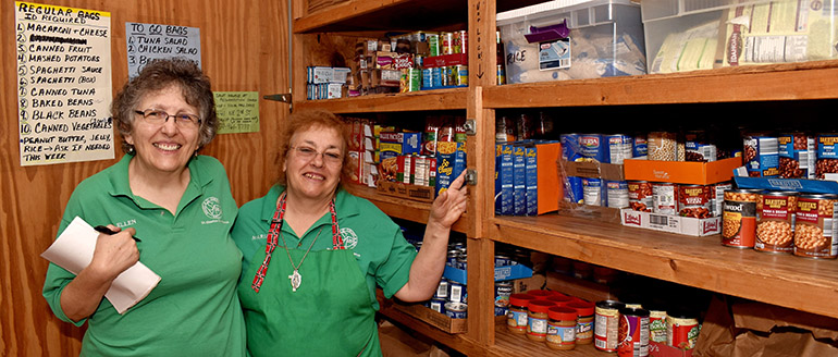 Ellen Volpicella, left, and Maria DiBenedetto show the pantry at St. Maurice Church, which serves about 45 persons each Thursday.