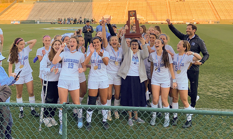 Lourdes Academy's Bobcats, along with coach Ramiro Vengoechea and the school's president, Immaculate Heart of Mary Sister Carmen Fernandez, celebrate their second soccer championship in three years, a 2-1 win against Venice in the Class 6A final, played Feb. 28, 2020 in DeLand.