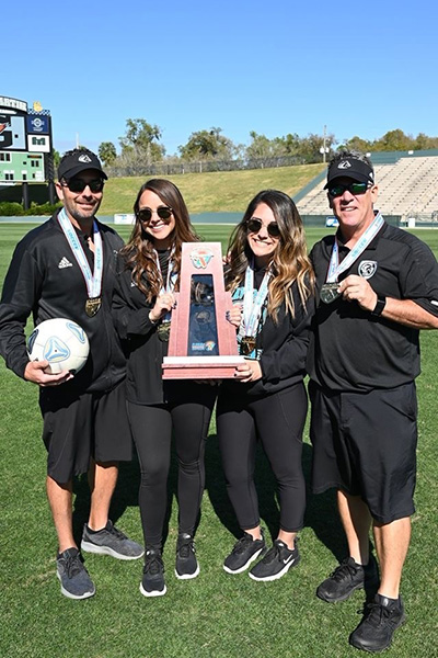 Coaches for Archbishop McCarthy High School's girls varsity soccer team, including head coach Mike Sica, far left, pose with their trophy and medals after winning the school's first state championship. They defeated Ponte Vedra 2-0 in the Class 5A game held Feb. 28, 2020 in DeLand. The Mavericks finished the season with a record of 22-1-2.