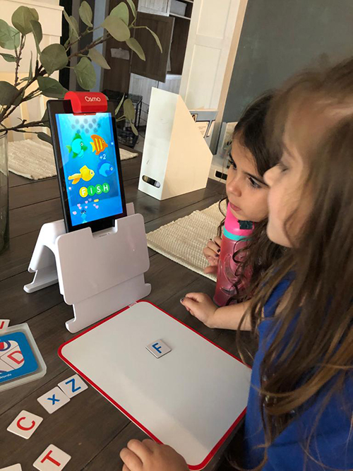 Emma and Ava Piñero use Osmo to play educational games.