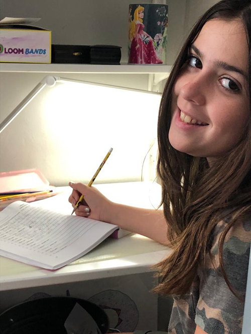 Brianna Piñero, 11, works on her Language Arts assignment.