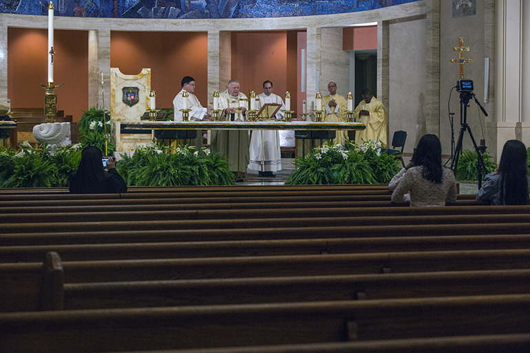 Due to the coronavirus pandemic, Archbishop Thomas Wenski celebrates the Easter Vigil in a nearly empty St. Mary Cathedral April 11, 2020. The Mass was livestreamed on the archdiocesan website and Facebook page.