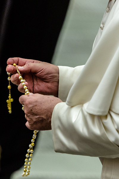 Pope Francis holds a rosary after the Wednesday general audience inside the Vatican's Paul VI Hall, Aug. 7, 2019.