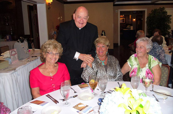 Msgr. James Fetscher poses with members of St. Sebastian's Council of Catholic Women at a recent event. The parish is marking its 60th anniversary, and he will be marking his 10th year as pastor in the fall.