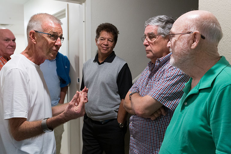 Father John Baker, rector of the Basilica of St. Mary Star of the Sea,  in Key West, speaks with Miami Catholic Charities senior staff and board members during a recent Charities field trip to the Florida Keys. In the middle is Peter Routsis-Arroyo, Catholic Charities CEO for the Archdiocese of Miami.