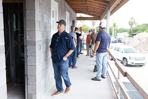 Miami Catholic Charities board member Craig Armstrong, CPA, gathers with the building and design crew at the future St. Bede's Village, a Catholic Charities project that will address the low income housing problem in the lower Florida Keys.