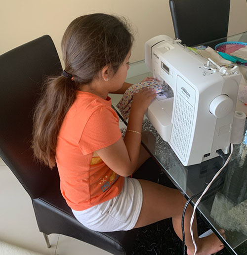 Valentina Torres learned how to sew with a sewing machine to earn a Girl Scout patch. Now, the St. Mark School third grader is making and donating masks for healthcare providers in hospitals and medical centers.