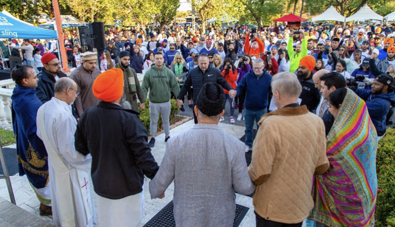 Leaders from various religious institutions in Southwest Ranches, including Archbishop McCarthy High, St. Mark Church and School, and the Archdiocese of Miami, take part in a unity prayer before the start of the 5K Run and Walk February 29.