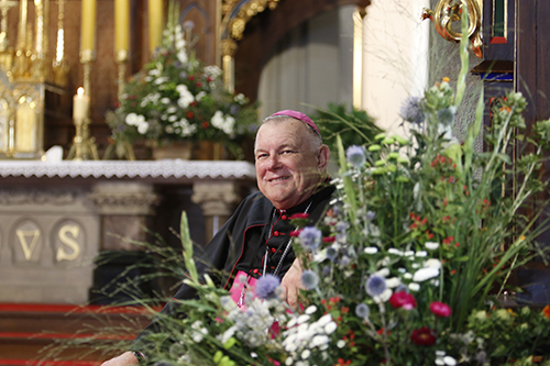 Archbishop Thomas Wenski looks out at the nave of St. Joseph Church in Krakow, filled with English-speaking young people from all over the world, as music ministers from the United Arab Emirates get the World Youth Day catechesis started.