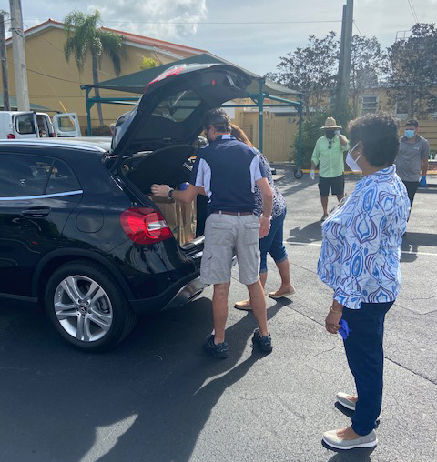 St. Rose of Lima volunteers take food donations out of a fellow parishioner's car during the food collection event April 29, 2020. School families and parish volunteers restocked neighboring St. Martha Parish's Food Pantry thanks to donations of nonperishable foods from their fellow parishioners.