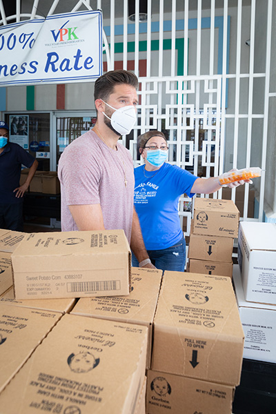 Professional baseball pitcher Steven Francis "Paco" Rodríguez volunteers at a Catholic Charities community food distribution at Centro Hispano Católico in Miami April 30, 2020. A Cuban-American, Rodríguez has played major league baseball for the Los Angeles Dodgers, the Atlanta Braves and the Baltimore Orioles among other teams. His mother, Gladys Palacios, is senior director of Child Development Services for Catholic Charities Miami.