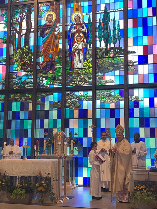 Archbishop Thomas Wenski celebrates Mass to dedicate a newly completed chapel and rectory at Nativity Church in Hollywood, May 3, 2020. Because of the coronavirus stay-at-home orders, the ceremony was livestreamed on the parish's website and Facebook page. At left is Nativity's pastor, Father David Zirilli.