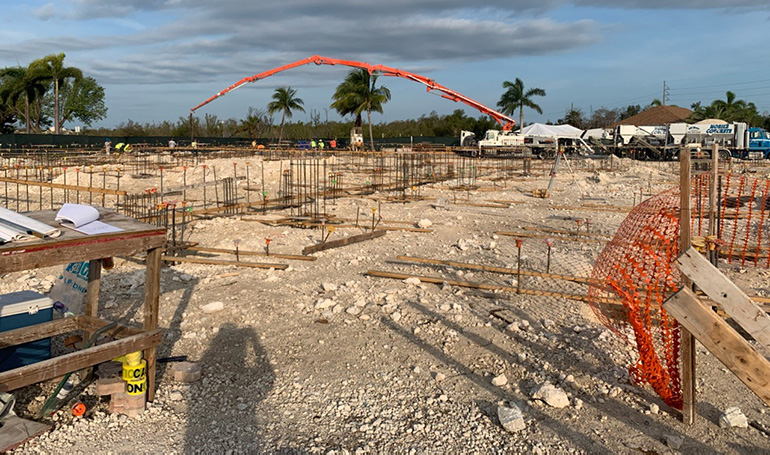 Early in the morning of May 7, 2020, an extended pump truck creates a rainbow over St. Peter Church in Big Pine Key, as it begins pouring 347 cubic yards of concrete to form the foundation for a new church. The old one was damaged by Hurricane Irma in 2017.