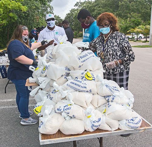 Volunteers prepare the bags of food to be given away at Notre Dame d'Haiti Church May 23, 2020. Archbishop Thomas Wenski helped Father Reginald Jean-Mary, Notre Dame d'Haiti pastor, hand out food at the church.