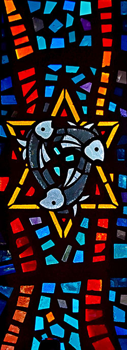 Three fish, representing Jesus, swirl over a Star of David, showing his Jewish heritage.