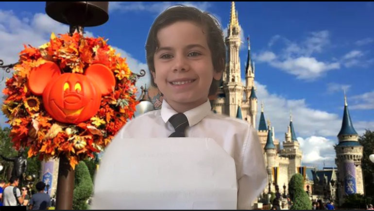 Dressed in his finest, and with a background of Magic Kingdom Park in Disney World, a student from St. Hugh School makes an online presentation during what would have been the "Book Parade" on May 4, 2020. Although classes took place online after March 17, 2020, assignments continued to be just as hands-on and creative.