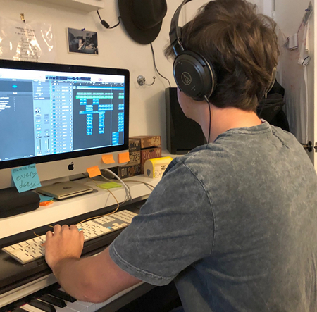 Pablo Amat, 17, a budding musician and student at Immaculata-La Salle High School in Miami, is shown here busy at work producing his music video.