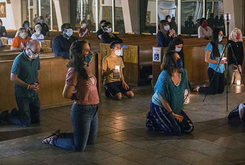 Young adults pray before the Blessed Sacrament during a Night of Prayer for the end of racism and for peace at St. Augustine Church in Coral Gables, June 9, 2020.