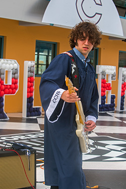 Christopher Columbus High School graduate Joseph Rodriguez plays the national anthem on his electric guitar at the start of the graduation ceremony. Because of the pandemic, the Miami school celebrated its graduation at the Homestead Miami Speedway, June 20, 2020.