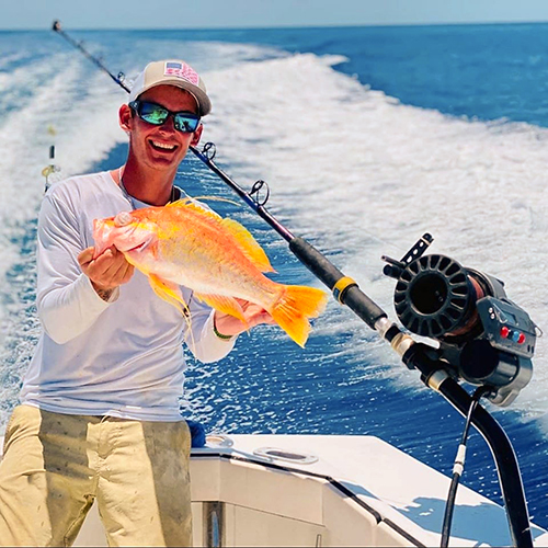 A.J. Staggs, a crew member of the Key West-based Linda D Sportsfishing charter boat, displays a longfined sea bass he caught recently as part of the St. Peter's Fleet partnership with the SOS Foundation and local charter boats.