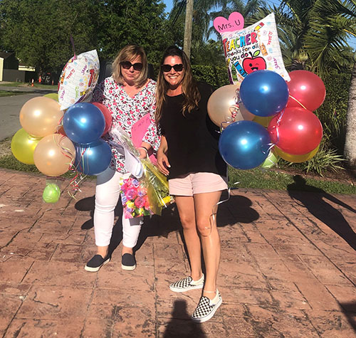 Blessed Trinity students showed their love for kindergarten teacher Melinda Usallan, right, and her assistant, Elena Martinez, by caravanning to Usallan's house and holding a parade in her honor. They showered her and Martinez with flowers, balloons and handmade cards.