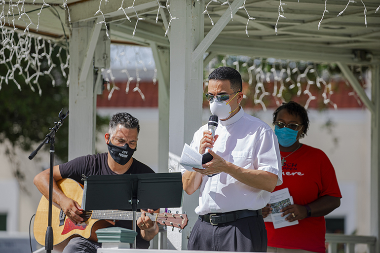 Father Jose Alfaro, pastor of Blessed Trinity Church, leads the prayer of confession inside the Miami Springs Circle Gazebo during the Unity Prayer Walk, June 27, 2020, 2020. At left is Pastor Sam Miranda from Crossbridge Church and at right is Rev. Ginger Medley, pastor of Poinciana United Methodist Church, both in Miami Springs.