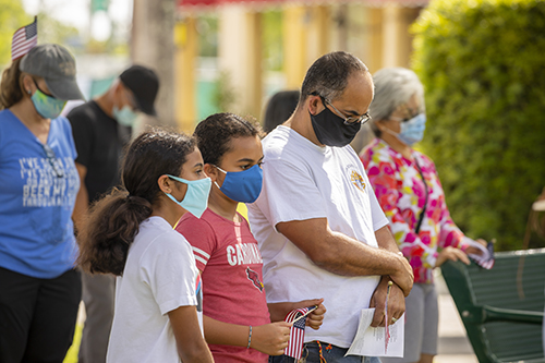 Blessed Trinity parishioner Lino De La Cruz and his daughters, from left, Jaylin and Alina, pray during the Unity Prayer Walk on June 27, 2020. The walk united people of faith from the area to peacefully pray for justice and reconciliation.