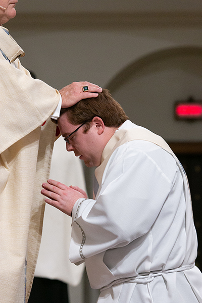 Archbishop Thomas Wenski lays hands on Deacon Andrew Tomonto, ordaining him "a priest forever."
Archbishop Thomas Wenski ordained two South Florida natives to the priesthood for the Archdiocese of Miami June 27, 2020. The ceremony had been postponed from May due to the COVID-19 outbreak, and was still punctuated by mask-wearing and social distancing among the limited number of both faithful and priests in attendance.