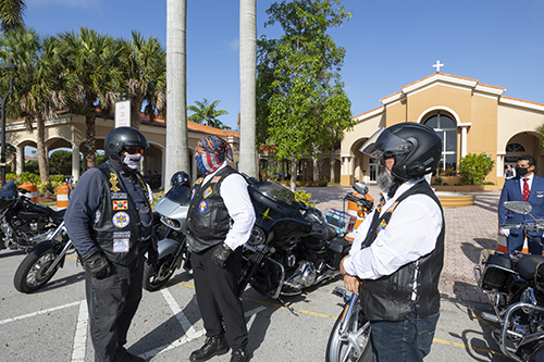 Archbishop Thomas Wenski, far left, talks to members of the Knights of Columbus Council 14390 and members of the Knights on Bikes outside St. John XXIII Church in Miramar, before departing on their two-hour motorcycle caravan to Ave Maria in the Diocese of Venice in west Florida, July 3, 2020.