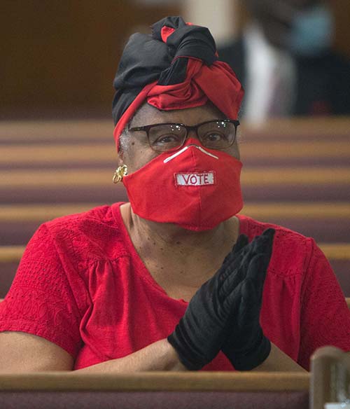 Elizabeth Davis prays during the Mass for unity against racism and for peace, celebrated by Archbishop Thomas Wenski July 5, 2020, at Holy Redeemer Church in Liberty City.