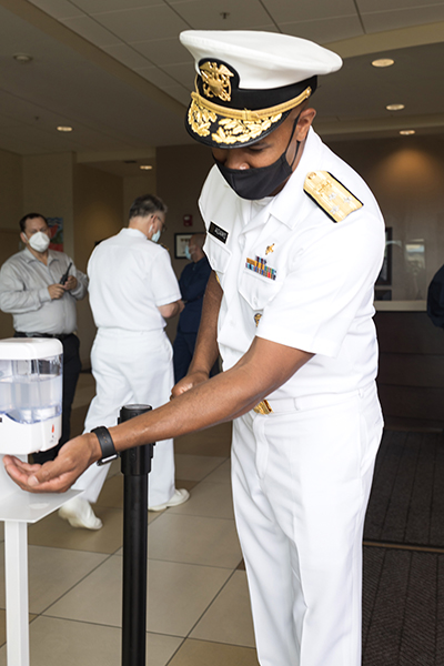 Dr. Jerome Adams, the 20th U.S. surgeon general, utilizes a hand sanitizer station at Camillus House shelter for the homeless and Camillus Health Concern in Miami, during a visit to South Florida July 23, 2020.