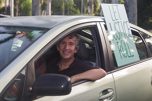 David Schatfield, of St. Stephen's Episcopal Church, sits in his car and listens to speakers during PACT's July 27, 2020 drive-in rally at Coral Gables Congregational Church.