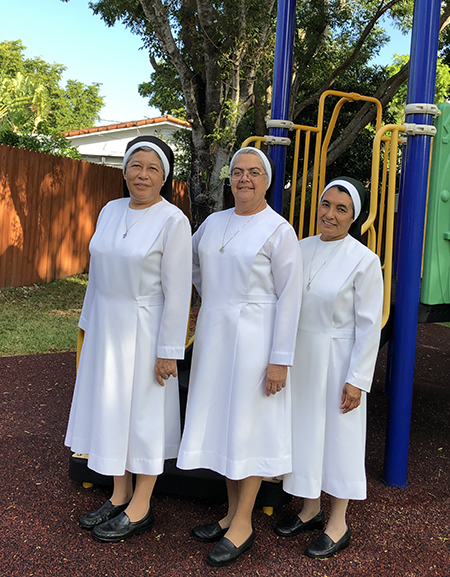 Posing for a photo in the playground of the Theatine Sisters Day Care, from left: Sister Maria del Rosario Gutierrez, the center's director; Sister Esther Samudio, the Miami community's religious superior; and Sister María Dolores Moya.