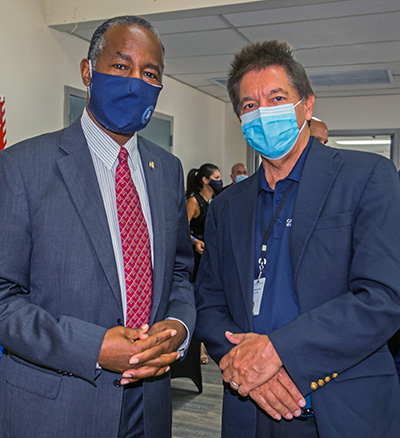 Catholic Charities Director Peter Routsis-Arroyo, right, poses for a photo with U.S. Housing and Urban Development Secretary Dr. Ben Carson during his visit to Catholic Charities' Malcolm Ross Senior Center, Aug. 13, 2020.