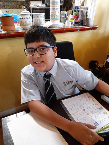 St. Michael the Archangel fifth grader Sebastian Fernandez is ready to "work from home" on the first day of the 2020-2021 school year, Aug. 19, 2020.