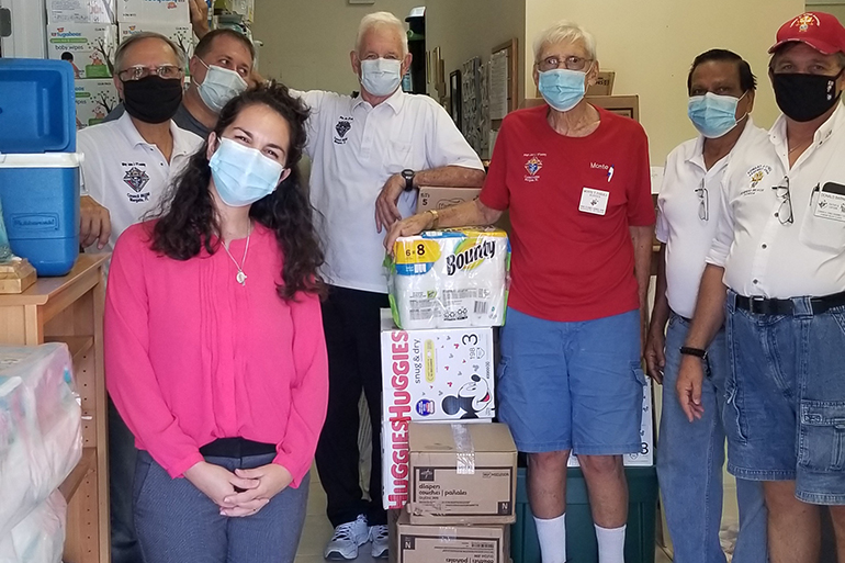 In late July, members of several Miami-area Knights of Columbus councils pitched in to help deliver some 20 pallets of baby supplies to area pregnancy help centers in the Archdiocese of Miami, according to James Buzzella, state disaster response coordinator for the Knights of Columbus in Miami. Some of the Knights are shown here posing with Katherine Lantigua, program coordinator of the South Broward Pregnancy Help Center.