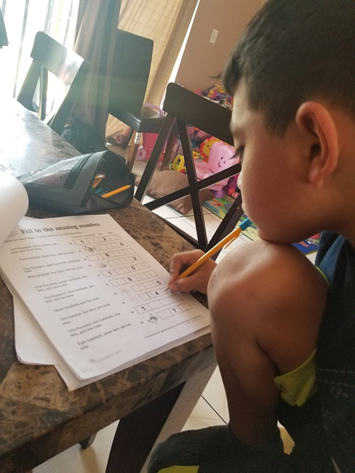 La Salle Educational Center student Kevin Silva keeps up with his virtual schoolwork back in April, in this photo taken by his mother, Reina Ramirez Silva, which the center posted on its Instagram account. With the COVID-19 pandemic, all schools finished the 2019-2020 academic year online. La Salle's team checked in on a weekly basis with children who attended the center.