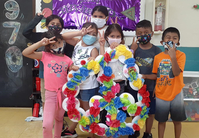 Peace and love all around: Inspired by the 1970s, campers from La Salle Educational Center show off a giant tissue paper peace sign they made to celebrate the decade. Amid the COVID-19 pandemic, the center opened up for an in-person camp from June 15-Aug. 7, 2020, and allowed kids to explore American history through music, activities, and even foods from different decades.