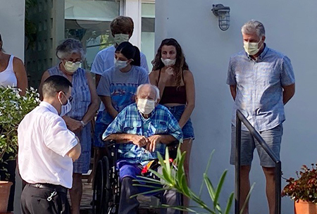 Father Jose Alfaro, pastor of Blessed Trinity Church in Miami Springs, along with several parishioners from his parish, visit a family to pray with them during the COVID-19 pandemic. Father Alfaro's efforts to reach parishioners is in concordance with the new document on the parishes drawn up by the Holy See.