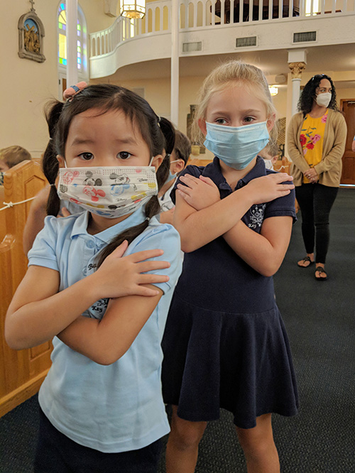 Students in preschool at The Basilica School of St. Mary Star of the Sea in Key West receive blessings as they return back to school in August 2020.