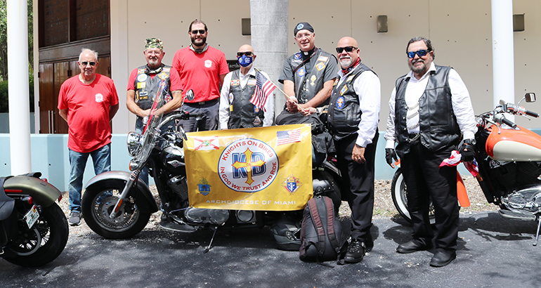 Knights on Bikes from the Archdiocese of Miami pose with members of the Knights on Bikes of Illinois in front of St. Martha Church, Miami Shores, Sept. 17. 2020. From left: Dale Saunders, Lance Maki, Tony Orband, Sergio Alfonso, Father James Heyd, George Gutierrez and Mario Rangel. The Knights stopped at the Pastoral Center and celebrated Mass with Archbishop Thomas Wenski at St. Martha Church next door. They were riding to northern Florida along U.S. 1, to raise awareness about the rights enshrined in the First Amendment to the U.S. Constitution, notably freedom of religion and speech.