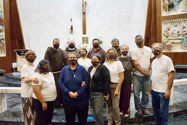 After the rite of admission of a new member to the Secular Franciscan Order – Espejo de Cristo (Mirror of Christ) all fraternity members pose with members of the Order of Friars Minor assigned to the recently erected St. Pio Friary located on the grounds of St. Jerome Parish in Fort Lauderdale, last September at Immaculate Conception Parish in Hialeah.