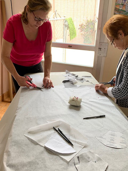 Hilda Aguilera, OFS, minister of the Secular Franciscan Order Espejo de Cristo (Mirror of Christ), and her mother Hilda Nieves cut patterns to make masks.