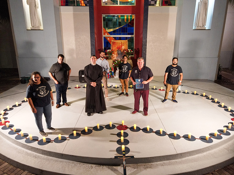 St. Thomas University President David Armstrong, second from right, and Father Rafael Capo, vice president of Mission, pose with students who took part in the Rosary Rally held Oct. 7, 2020, feast of the Holy Rosary. Nearly 80 St. Thomas University students took part in the rally, which was led and organized by the university's campus ministry office and held outside St. Anthony Chapel on campus.