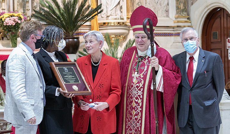 Senior Judge Patricia Seitz, standing next to Archbishop Thomas Wenski, presented the Miami Catholic Lawyers Guild's highest honor, the Lex Christi, Lex Amoris award, to Randy McGrorty, far left, and Myriam Mezadieu, executive director and COO, respectively, of Catholic Legal Services. The presentation took place at the conclusion of the annual Red Mass organized by the Miami Catholic Lawyers Guild, whose president, Francis Sexton, is pictured at far right. The Mass was celebrated Oct. 29, 2020.