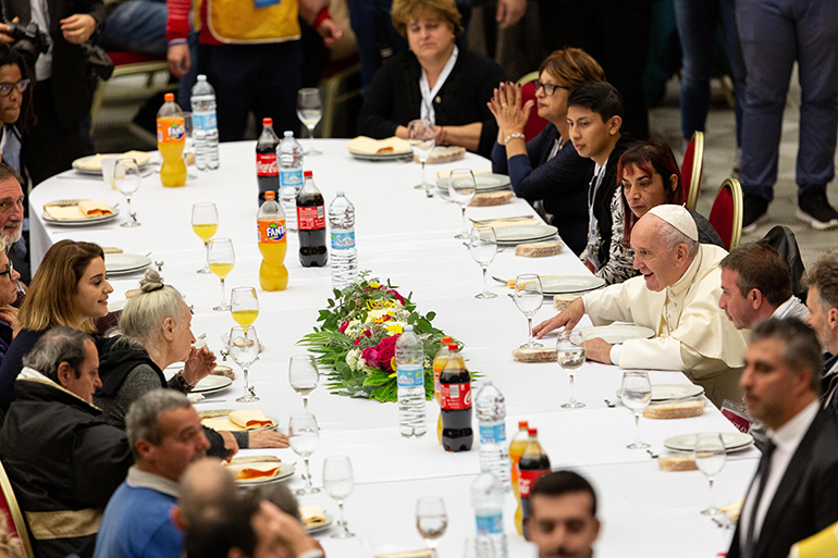Pope Francis shares a free lunch with nearly 1,500 poor people invited to dine in the Vatican's Paul VI Hall for the Third annual World Day of the Poor on Nov. 17, 2019. In his new encyclical, Fratelli tutti, Pope Francis states that populism could conceal a lack of concern for the vulnerable, while liberalism could be used to serve the economic interests of the powerful.