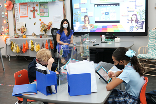 Jennifer Sardina teaches the second graders sitting before her in class as well as students learning at home online. St. Bonaventure School opened its campus at the end of September and welcomed students back to the classrooms. Some are still participating in virtual classes due to the pandemic.