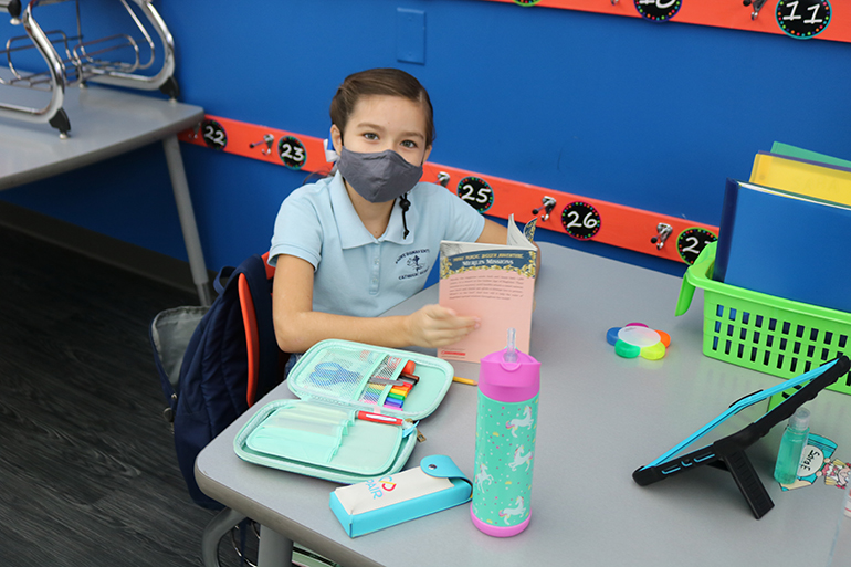 Sara Echeverri is enjoying some reading during class at St. Bonaventure School in Davie.